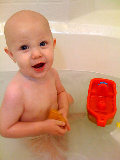 James playing with pirate toys in the bathtub