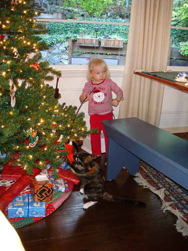 Dora and Kate play by the Christmas tree