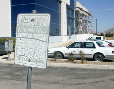A faded sign for a former tenant outside the new Hesperia Unified School District offices on Main Street